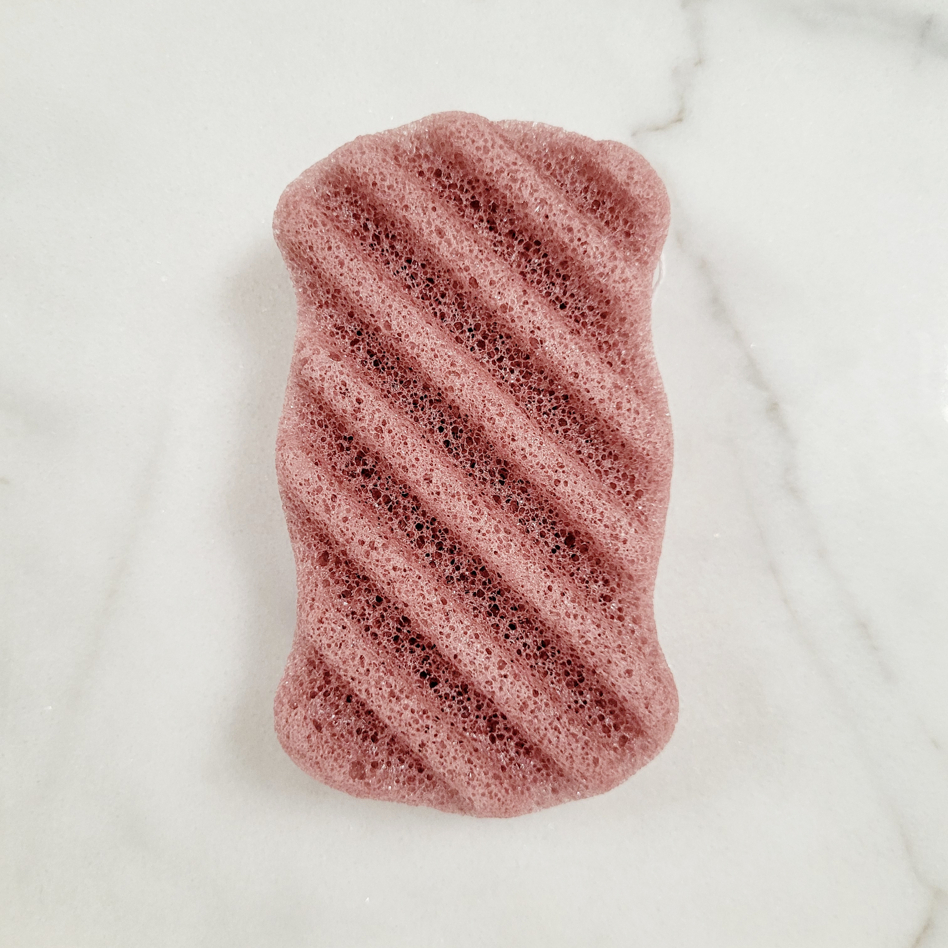 A flat lay of each Konjac Sponge in French Red clay color, showcasing variety in natural, eco-friendly exfoliating sponges.