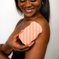 A woman gently holding a biodegradable Konjac Sponge, designed for deep cleansing, soft exfoliation, and a radiant glow.