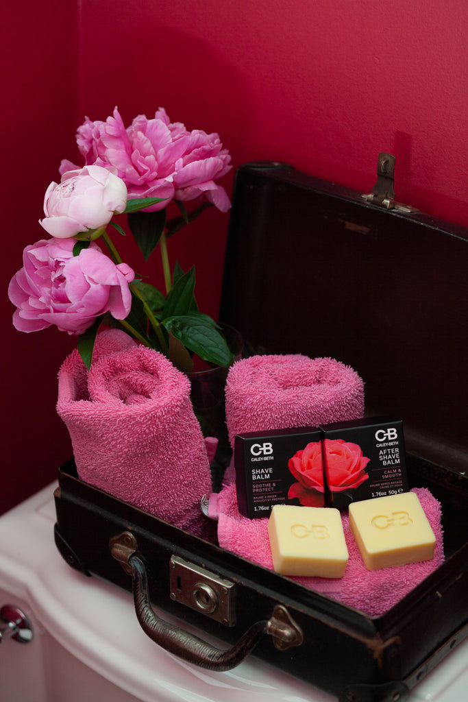 Caley-Beth's eco-friendly Shave Balm Bar and After Shave Balm Bar on a pink towels and flowers.