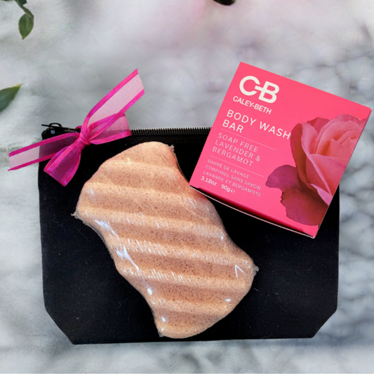 The Perfectly Polished Bathing Set featuring a soap-free Body Wash Bar, Konjac Exfoliating Sponge, and Black Canvas Travel Bag. Made in Canada with natural ingredients.