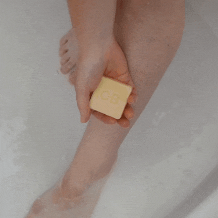 A person applying the Caley-Beth Shave Balm Bar, which turns into a lotion when activated with water for a comfortable, hydrating shave. Made in Canada.