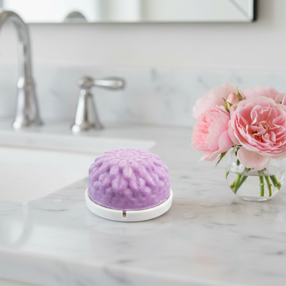 Lavender and Bergamot body wash bar on white soap saver dish, showing how to keep bars dry and longer lasting.