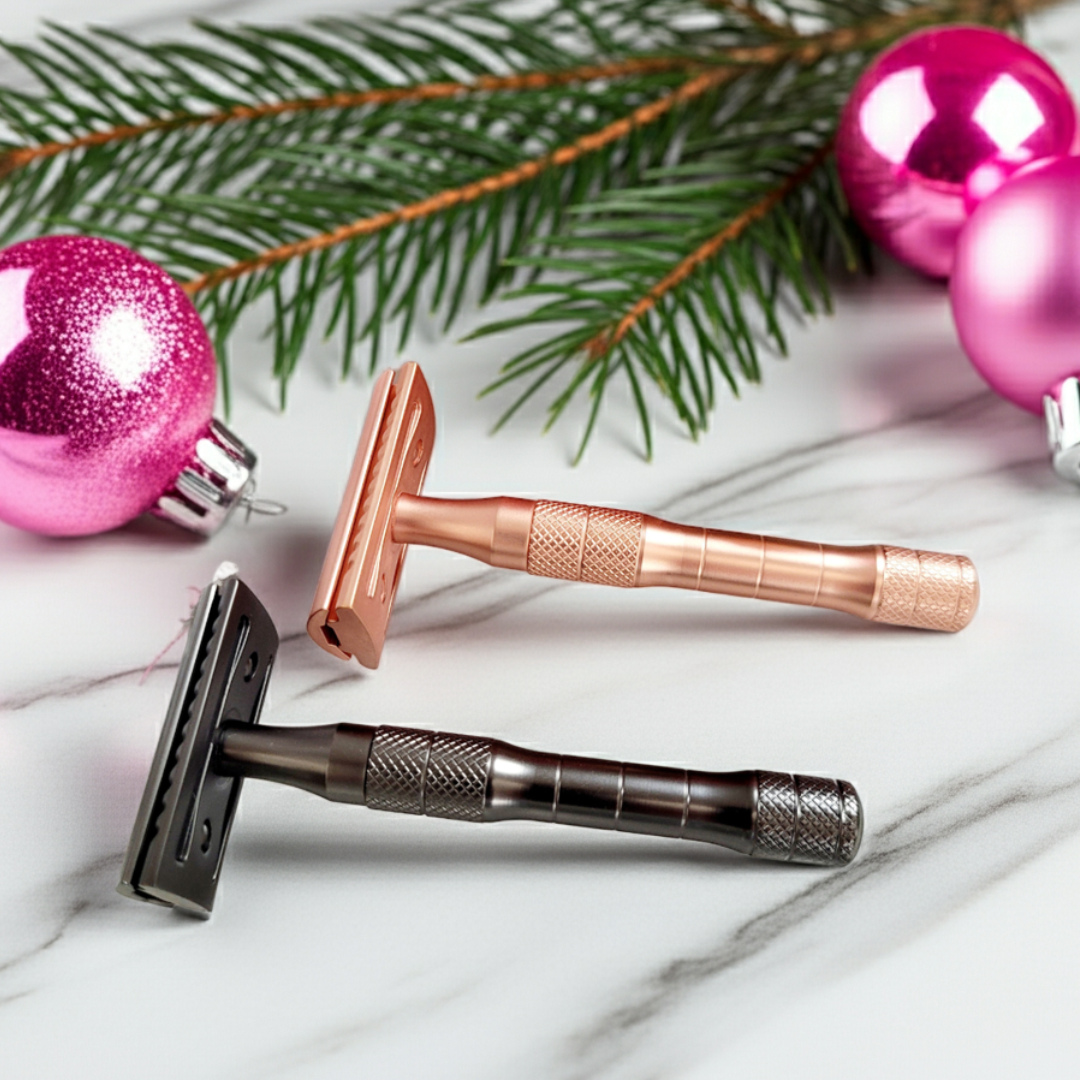 Safety razors in rose gold and matte black surrounded by festive holiday decorations, a thoughtful holiday gift for sustainable shaving and grooming.