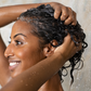 Woman using Conditioner Bar in the shower. A natural, zero-waste hair care solution made in Canada for soft, healthy-looking hair.