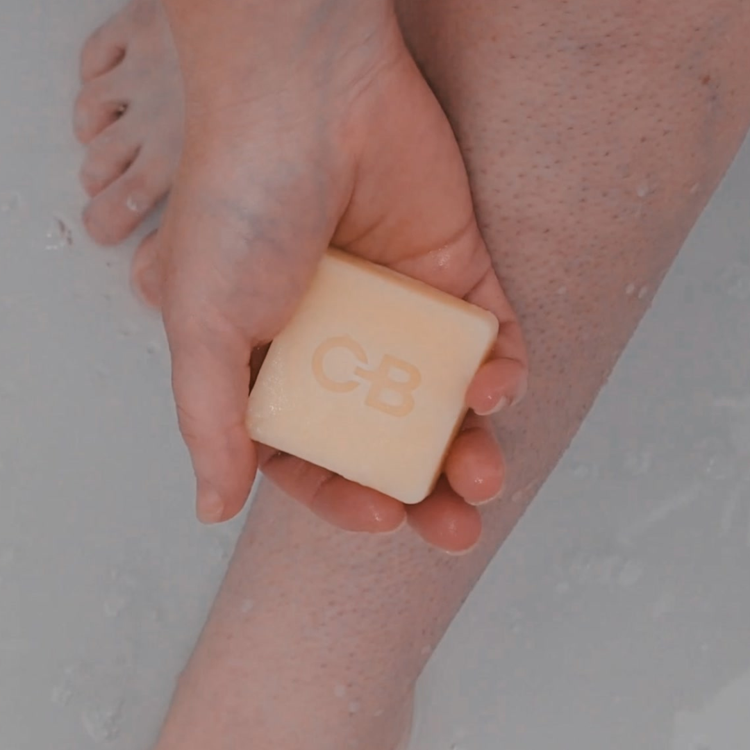 A Caley-Beth Shave Balm Bar held in hand, ready to provide a hydrating, irritation-free shave with its nourishing formula. Made in Canada and plastic-free.