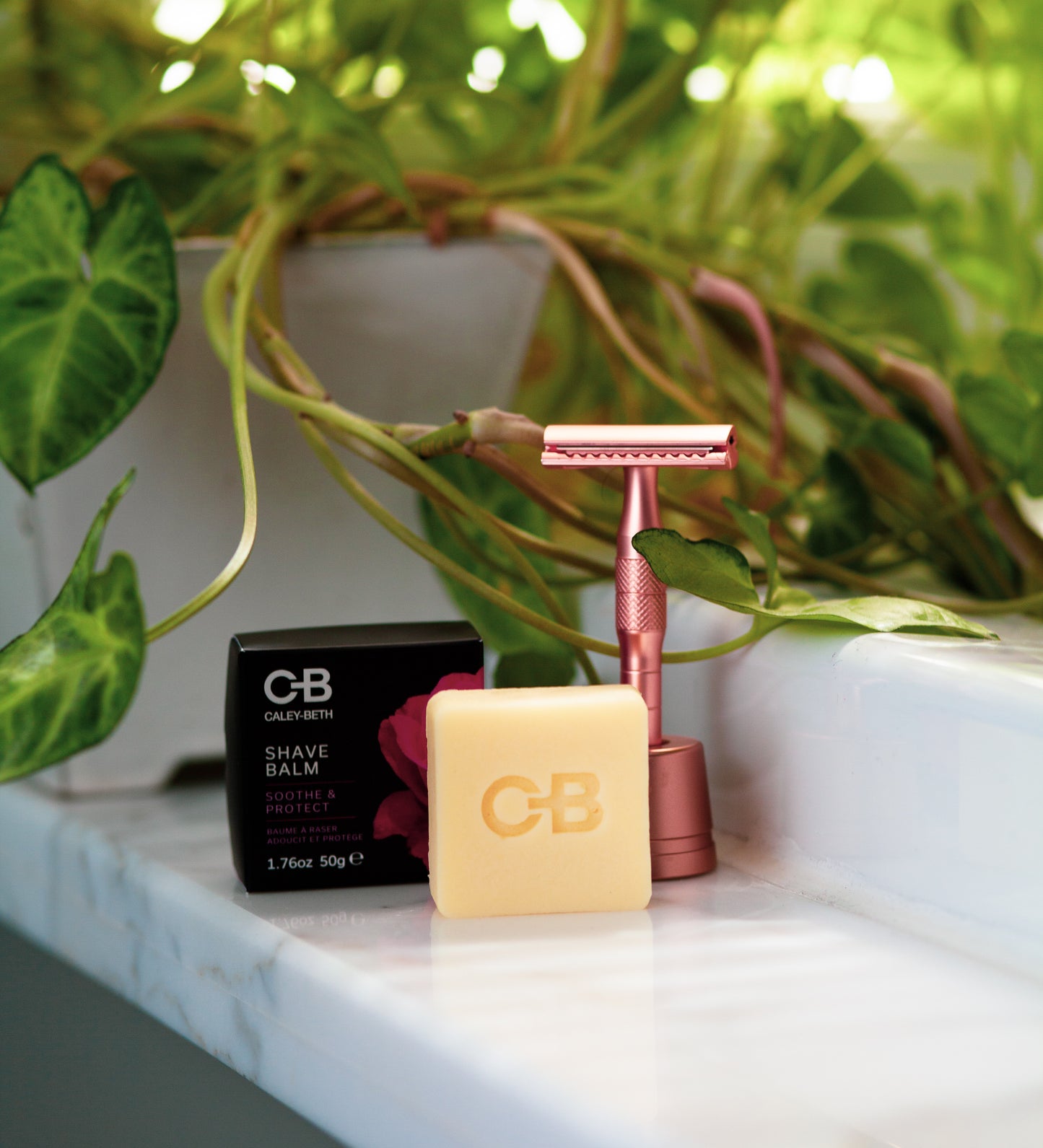  A Caley-Beth Shave Balm Bar next to a razor, designed to provide a silky-smooth shave without irritation or razor burn. Canadian-made.